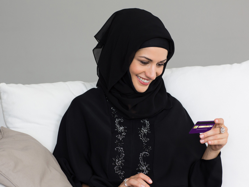 An Emirati woman using a card